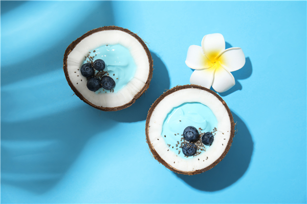 Canva - Coconuts with yummy spirulina smoothie on color background, top view.jpg